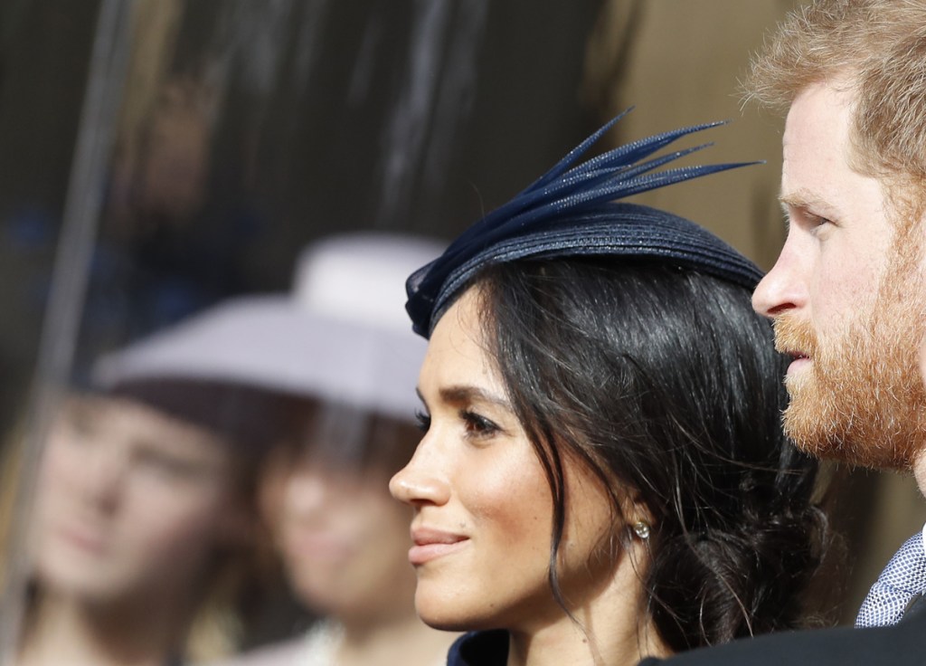 Prince Harry and his wife Meghan, Duchess of Sussex, smile as they wait for the bridal procession at the wedding of Princess Eugenie of York and Jack Brooksbank in St George's Chapel, Windsor Castle, near London, England on Oct. 12, 2018.
