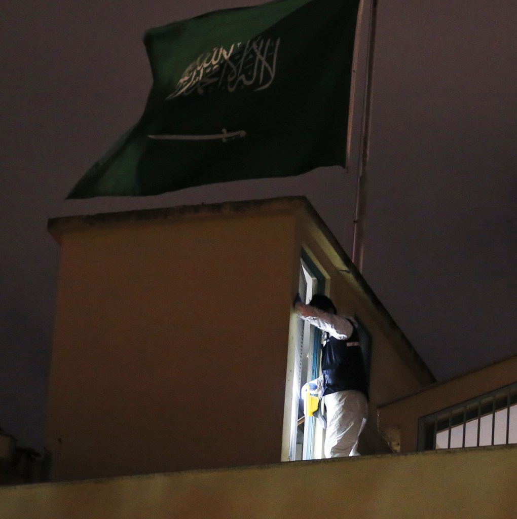 A Turkish police officer searches Monday for evidence on the rooftop of Saudi Arabia's consulate in Istanbul.