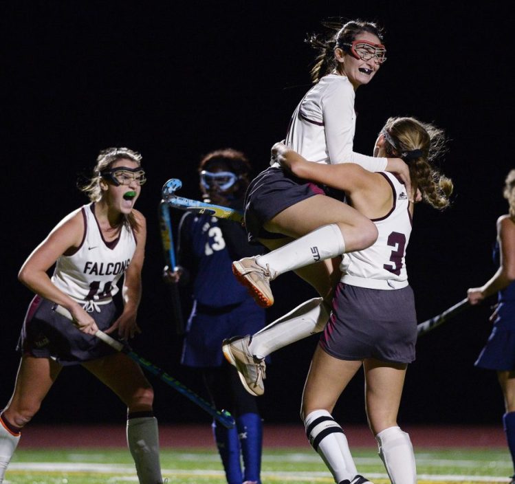 Natalie Anderson jumps into the arms of Alexa Koenig Tuesday after Keonig scored a late goal to put Freeport ahead in its playoff win over Poland.