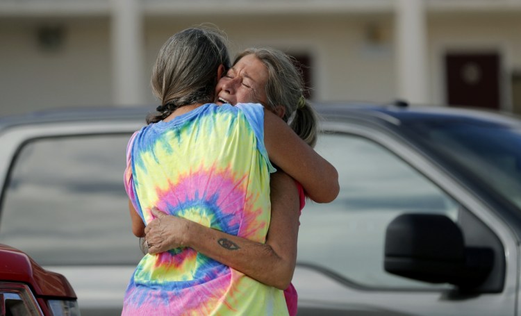 Nancy Register, right, weeps as she is comforted Wednesday by Roxie Cline, after she lost her home to Hurricane Michael in Mexico Beach, Fla.