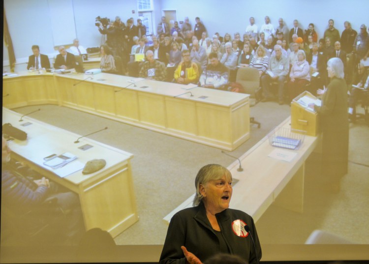 Sheryl Harth of Jackman testifies against the CMP corridor proposal on Wednesday at the Maine Public Utilities Commission office in Hallowell. She said, "Stay away from our wilderness."