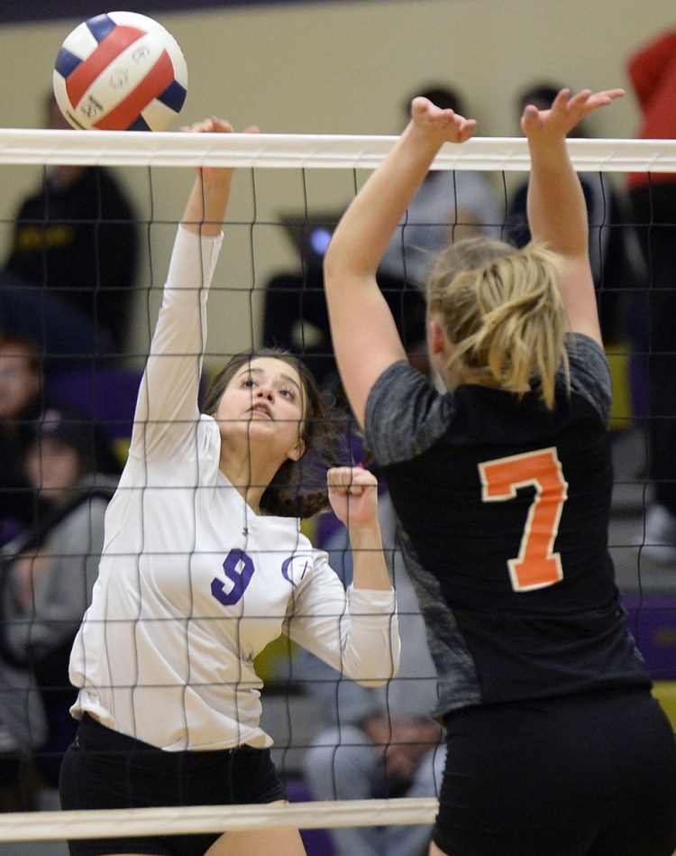 Kristina Matkevitch of Cheverus hits the ball past Sabrina Cooper of Brunswick during Cheverus' three-game sweep Thursday night to reach the Class A volleyball quarterfinals.