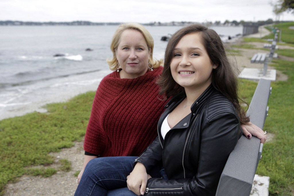 In this Monday, Oct. 8, 2018 photo Jeanne Talbot, left, and her transgender daughter Nicole Talbot, 17, both of Beverly, Mass., sit for a photograph at a park, in Beverly. In the first major electoral test in a U.S. state, opponents are asking voters to overturn a 2016 Massachusetts law that bars discrimination against transgender people in public accommodations, including restrooms and locker rooms.