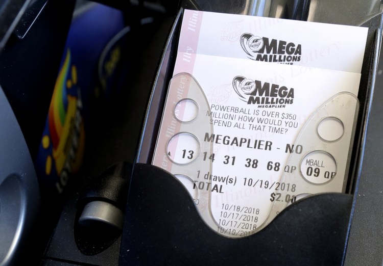 Mega Millions lottery tickets are printed out of a lottery machine at a convenience store Wednesday in Chicago. The estimated jackpot for Friday's drawing would be the second-largest lottery prize in U.S. history with a jackpot estimated to be $1 billion.