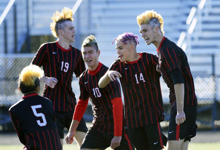 Scarborough players Marcus McKeough, Daniel Travers, Elliot Dumais, Brian Farino and Liam Bridgham, from left to right, celebrate a goal by Bridgham in a 2-0 win over Thornton Academy during a Class A South boys' soccer prelim Friday afternoon.