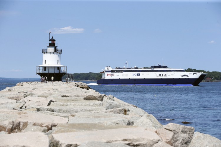 The Cat ferry passes Spring Point Ledge Light on its way out of Portland Harbor on a run to Nova Scotia in July. Bay Ferries, operator of the ferry, plans to move its Maine operations out of Portland to Bar Harbor, after its town council voted last week on an agreement allowing the Cat to use a terminal there.