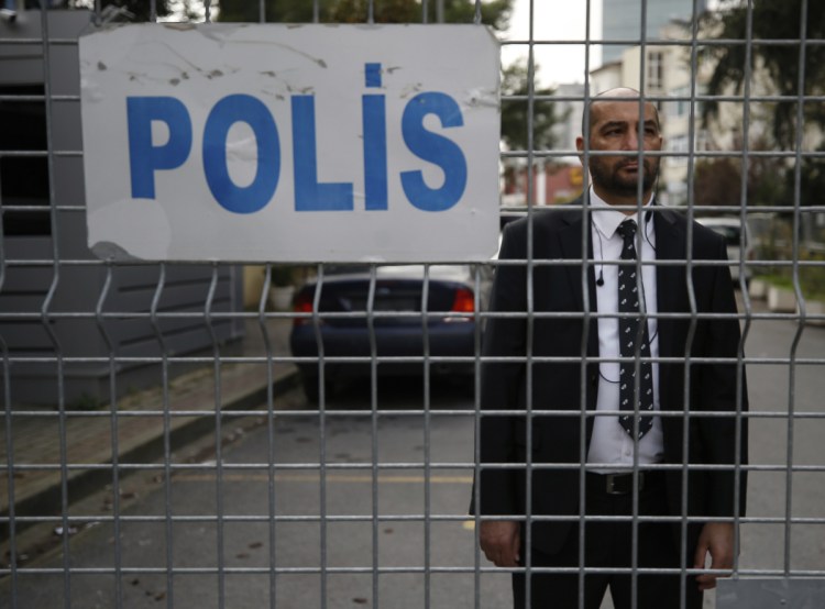 A security guard stands behind barriers blocking the road leading to Saudi Arabia's consulate in Istanbul on Saturday. Saudi Arabia announced hours earlier that journalist Jamal Khashoggi died during a "fistfight" in its consulate.