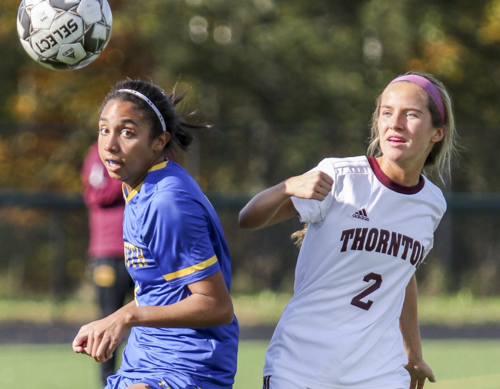 Aimee Muscadin, left, of Falmouth and Thornton Academy's Shannon Roche keep their eyes on the ball during Falmouth's 2-1 win in a Class A South soccer prelim Saturday.