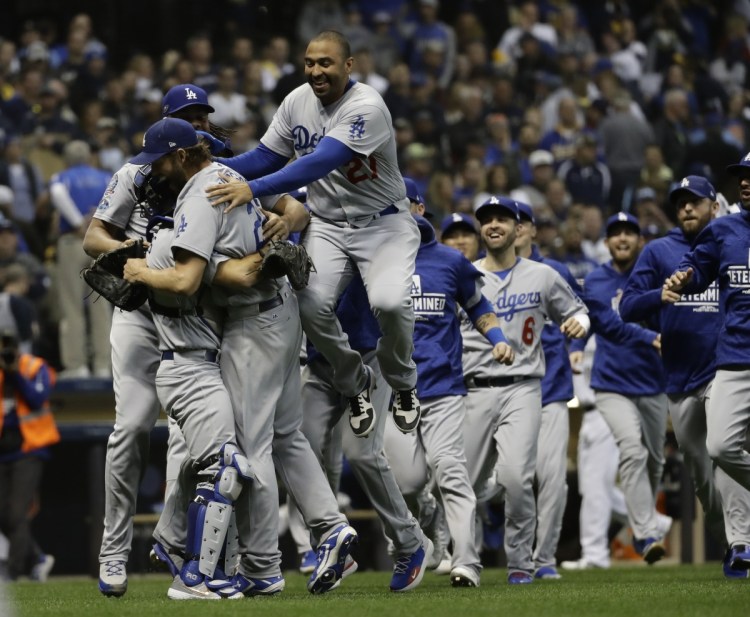 The Los Angeles Dodgers celebrate after Game 7 of the National League Championship Series on Saturday in Milwaukee. The Dodgers won 5-1 to win the series.