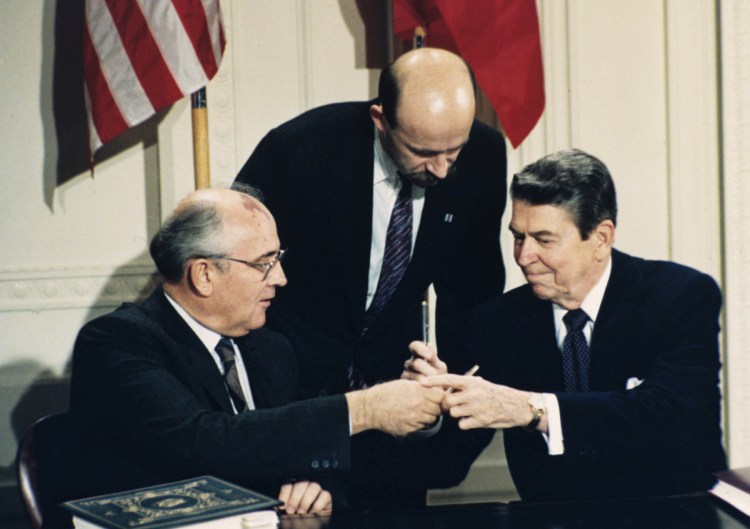 President Ronald Reagan and Soviet leader Mikhail Gorbachev exchange pens during the Intermediate Range Nuclear Forces Treaty signing ceremony on Dec. 8, 1987, at the White House. Gorbachev's translator Pavel Palazhchenko stands in the middle.