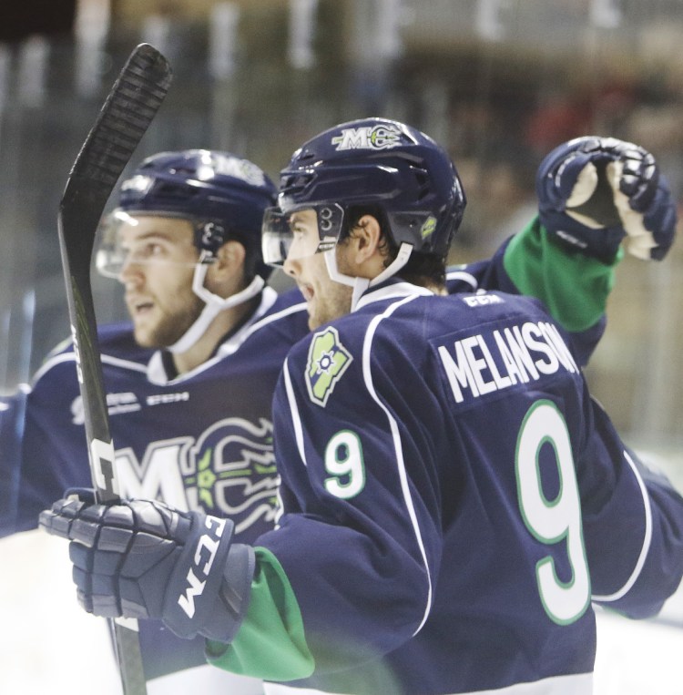 Drew Melanson of the Maine Mariners celebrates his first-period goal with teammate Derek Pratt during a 4-2 victory against the Newfoundland Growlers at the Cross Insurance Arena on Sunday.