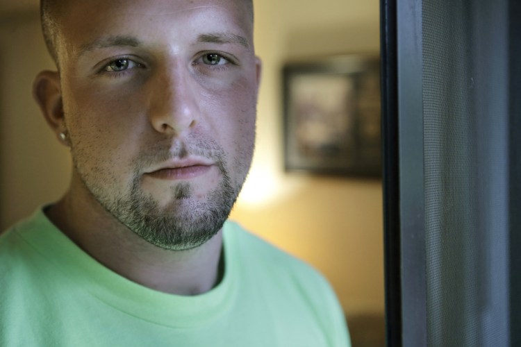 Michael Robinson, of North Reading, Mass., in recovery from heroin addiction, stands for a photo at his mother's apartment, in North Reading. Robinson recently became a union carpenter and has been working on building projects across the Boston area since. In Massachusetts, with Medicaid expansion already paying for opioid addiction treatment, emergency money from Congress goes largely toward recovery services.