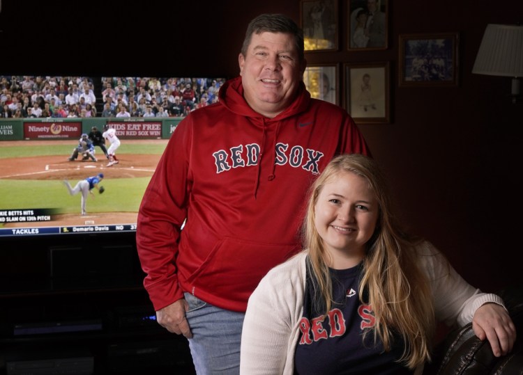 Craig Skeffington and his daughter Hannah watch Red Sox games together in the living room of their South Portland home. Hannah and Skeffington's other daughter are not "preconditioned" to expect failure, as he is.
