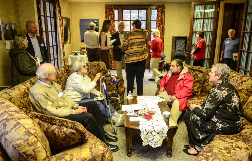 People chat in a downstairs room Tuesday at the First Amendment Museum in Augusta. Staff photo by Joe Phelan