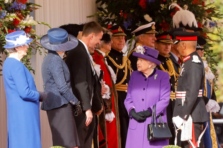 Britain's Queen Elizabeth II, center, speaks with Theresa May, U.K. prime minister, second left, and Jeremy Hunt, U.K. foreign secretary, third left, at a ceremonial arrival event to welcome Dutch King Willem-Alexander and Queen Maxima for their state visit to London on Tuesday. 