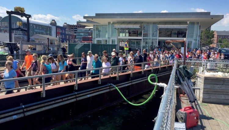 Lines form for a Casco Bay Lines ferry in July. During one three-hour period over the Fourth of July this summer, nearly 2,000 people rode ferries to Peaks Island alone.