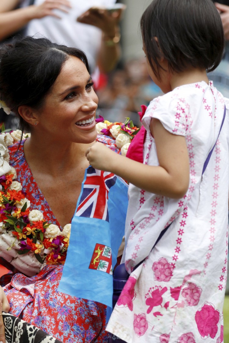 The duchess of Sussex greets Natasha Manuela, 3, in Suva, Fiji, on Wednesday. 