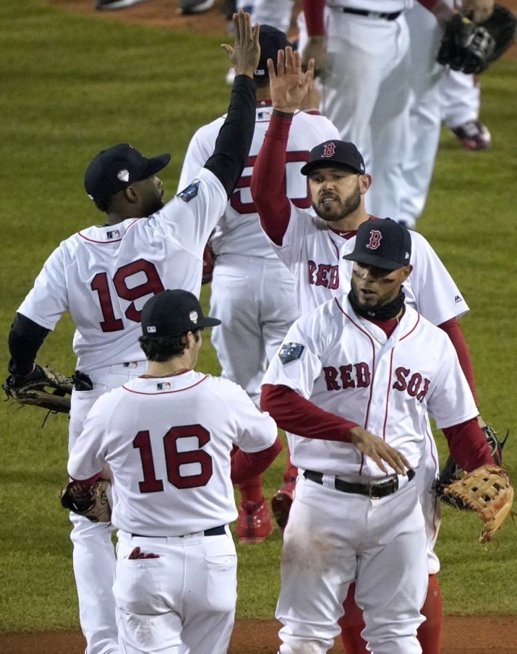 The Boston Red Sox celebrate after their 4-2 win over the Los Angeles Dodgers in Game 2 of the World Series on Wednesday in Boston. (AP Photo/Elise Amendola)