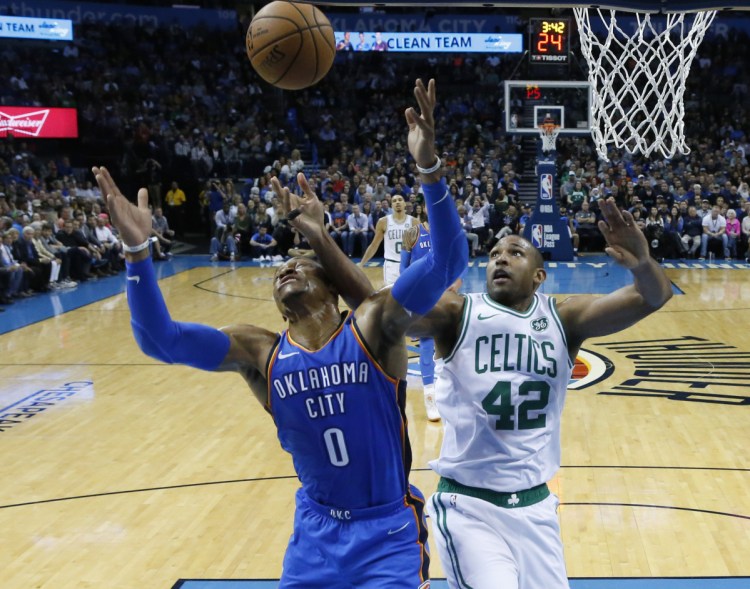 Oklahoma City's Russell Westbrook and Boston's Al Horford reach for a rebound in the first half Thursday night in Oklahoma City.