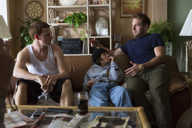 This image released by A24 shows writer-director Jonah Hill, right, with cast members Lucas Hedges, left, and Sunny Suljic during the filming of "Mid90s." 