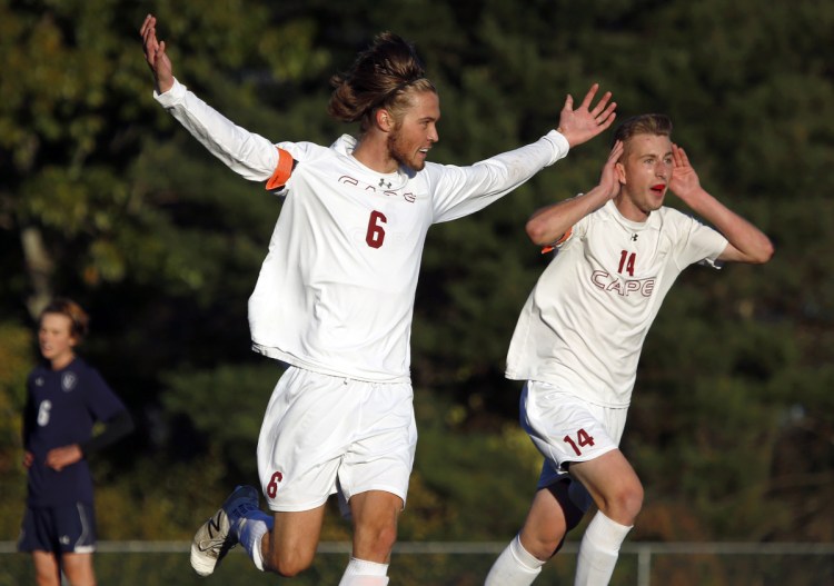 Phil Tarling, center, celebrates with John O'Connor after scoring the goal that gave Cape Elizabeth a 2-0 lead on the way to a 2-1 win that broke Yarmouth's 45-game unbeaten run in a Class B South semifinal.
