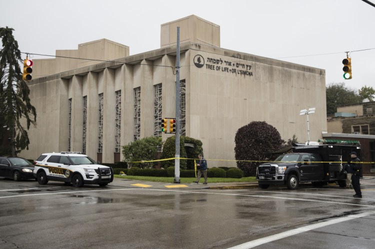 Police stand guard outside the Tree of Life synagogue in Pittsburgh where a shooter opened fire Saturday.