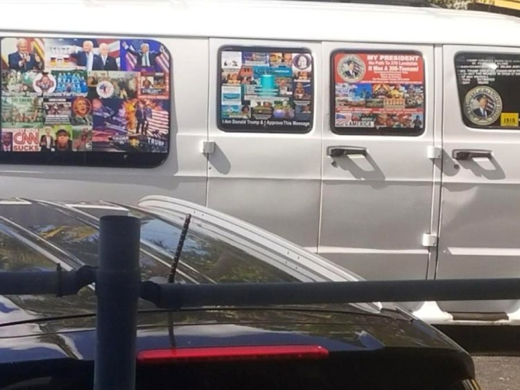 Photo shows a van with windows covered with an assortment of stickers in Well, Fla. Federal authorities took Cesar Sayoc, above, into custody on Friday.