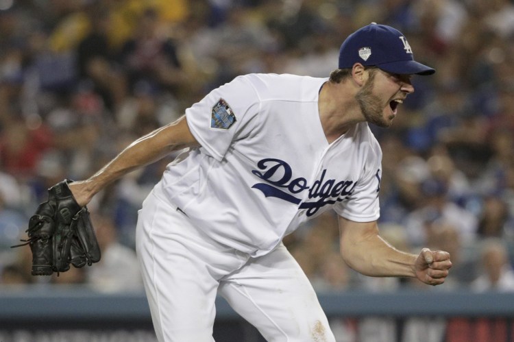 Dodgers starting pitcher Rich Hill celebrates after the last out in the top of the sixth inning against the Boston Red Sox in Game 4 of the World Series on Saturday in Los Angeles. He was pulled in the seventh inning despite allowing just one hit. (AP Photo/Jae C. Hong)