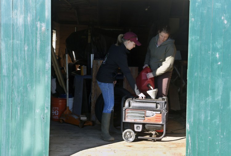 Emma Christman, 17, helps her mother, Jana, fuel a generator in the shed at their Litchfield home on Oct. 31, 2017.