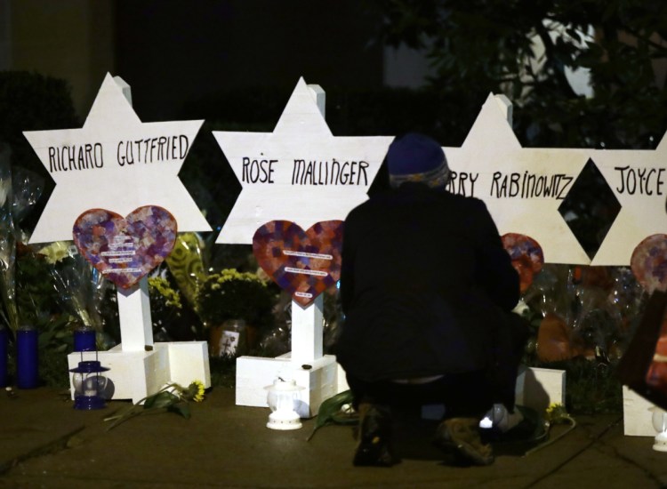 Stars of David with the names of those killed in a deadly shooting at the Tree of Life Synagogue stand in front of the synagogue in Pittsburgh on Sunday.