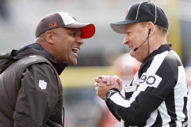 Cleveland Browns head coach Hue Jackson, left, talks with line judge Mike Spanier along the sideline as his team plays against the Pittsburgh Steelers on Sunday in Pittsburgh. The Steelers won 33-18. Jackson was fired Monday.