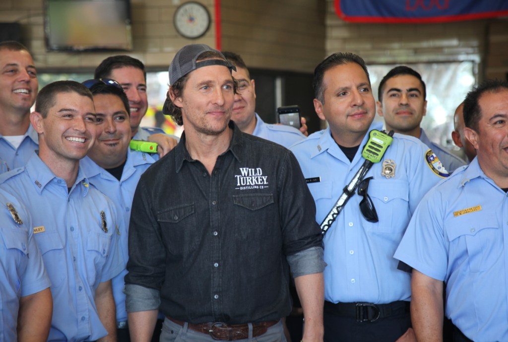 Actor Matthew McConaughey poses with first responders in Houston as he surprised them with catered lunches.
