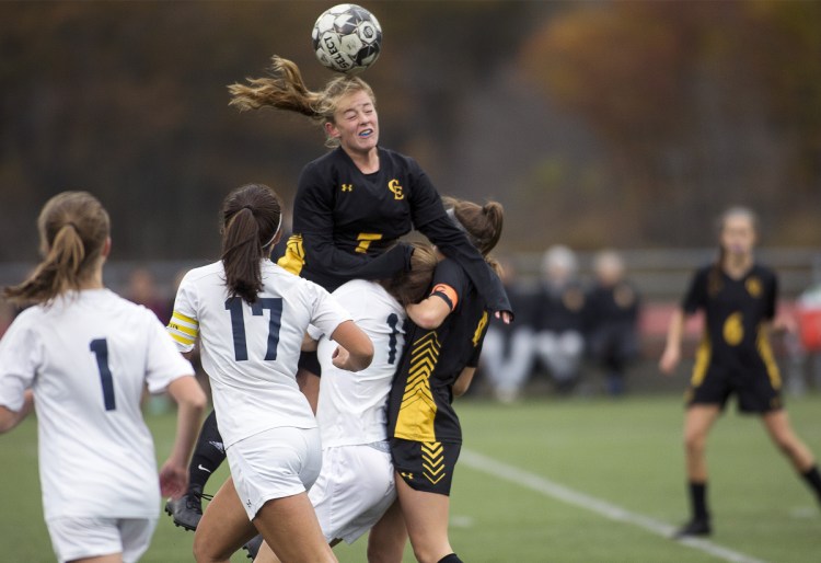 Cape Elizabeth's Karli Chapin, center, jumps over a group of players for a header during the Class B South semifinal against Yarmouth on Monday. Chapin had an assist and the Capers won 2-1.