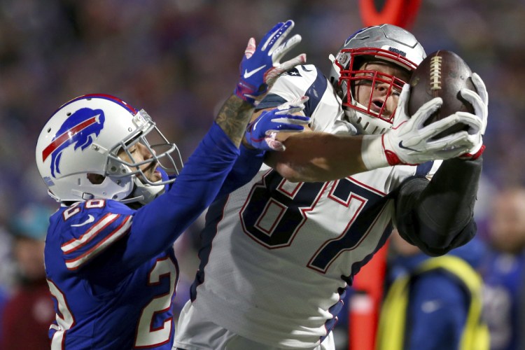 Patriots tight end Rob Gronkowski, right, makes a catch against Buffalo defensive back Phillip Gaines during the Patriots' 25-6 win Monday in Orchard Park, N.Y.