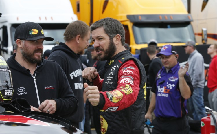 Martin Truex Jr., front right, talks to a crew member before qualifying for last Sunday's Cup Series race in Martinsville, Va., where Truex lost on Joey Logano's late bump-and-run.