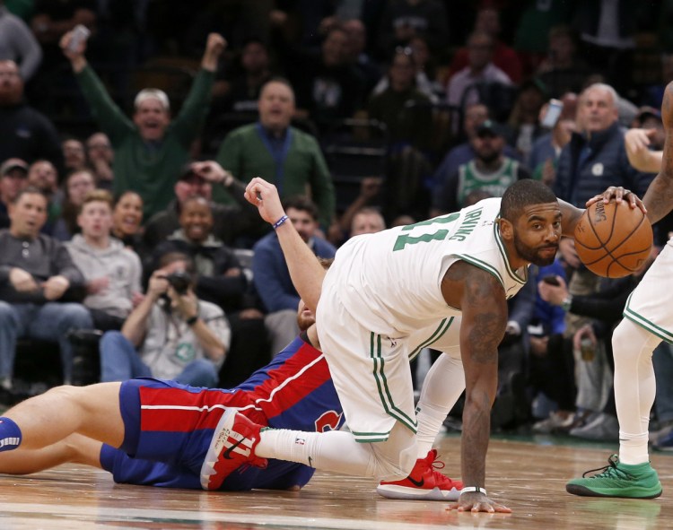 Boston's Kyrie Irving steals the ball from Detroit's Blake Griffin late in the fourth quarter Tuesday night in Boston. Irving had 31 points in Boston's 108-105 win.