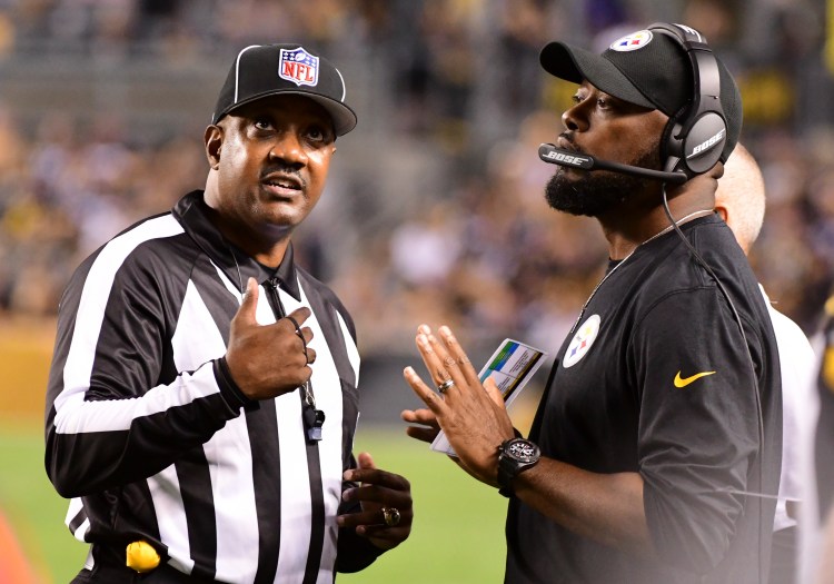 Pittsburgh Steelers head coach Mike Tomlin, right, talks with an official during the first half of the Steelers 26-14 loss to Baltimore on Sunday.