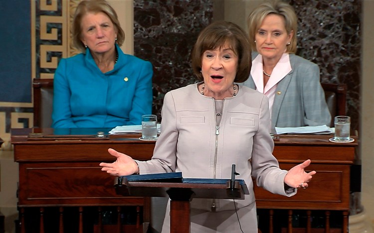 In this image from video provided by Senate TV, Sen. Susan Collins, R-Maine., speaks on the Senate floor about her vote on Supreme Court nominee Judge Brett Kananaugh, Friday, Oct. 5, 2018 in the Capitol in Washington.  Sen Shelly Capito, R-W.Va., sits rear left and Sen. Cindy Hyde-Smith, R-Miss., sits right. 