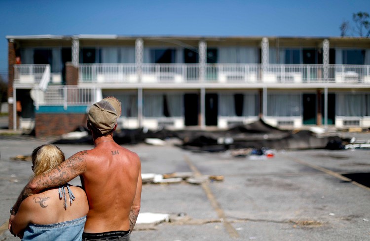 Residents line up for food from the Red Cross outside a damaged motel Tuesday in Panama City, Fla., where many residents have no place to go. Many of the rooms at the motel are uninhabitable.