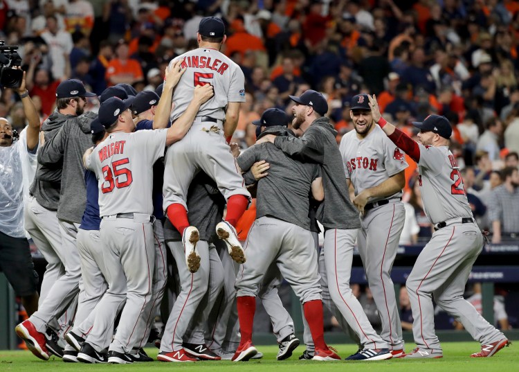 The Red Sox celebrate after winning the American League pennant with a 4-1 victory over the Houston Astros in Game 5 of the league championship series Thursday night in Houston.