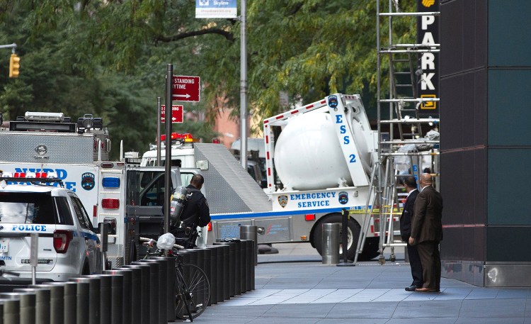 A New York police bomb squad vehicle leaves an area outside Time Warner Center on Wednesday after a package containing a pipe bomb prompted an evacuation of CNN's offices.
