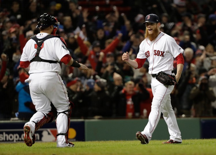 Boston Red Sox pitcher Craig Kimbrel celebrates with Christian Vazquez at the final out during the ninth inning of Game 2 of the World Series baseball game against the Los Angeles Dodgers Wednesday, Oct. 24, 2018, in Boston. The Red Sox won 4-2 to take a 2-0 lead in the series. (AP Photo/David J. Phillip)