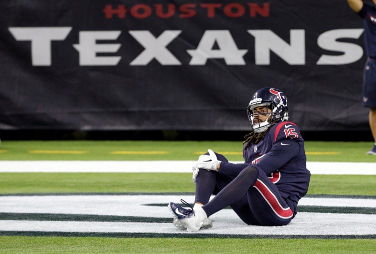Houston Texans wide receiver Will Fuller (15) holds his knee during the second half of an NFL football game against the Miami Dolphins on Thursday in Houston. 