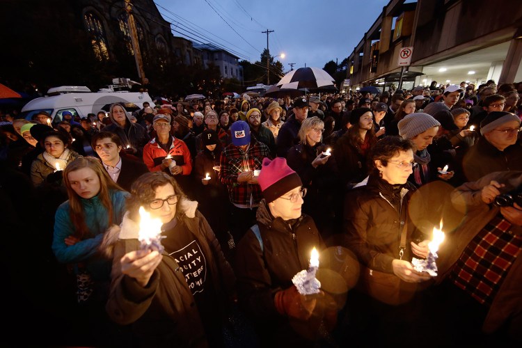 People hold candles as they gather for a vigil in the aftermath of a deadly shooting at the Tree of Life Congregation, in the Squirrel Hill neighborhood of Pittsburgh, on Saturday.