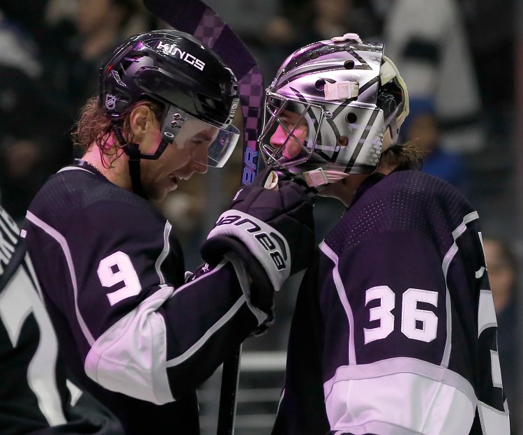 Los Angeles Kings goaltender Jack Campbell, right, celebrates with center Adrian Kempe after they defeated the New York Rangers on Sunday in Los Angeles.