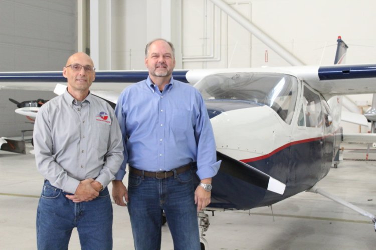 John Favreau, left, and David Keen of American Classic Flying Club stand with a Cesna Cardinal 177. Keen, who owns American Classic Aviation, said he and his instructors want to reach out to more young people to get them interested in flying careers. "It's a growth industry."

