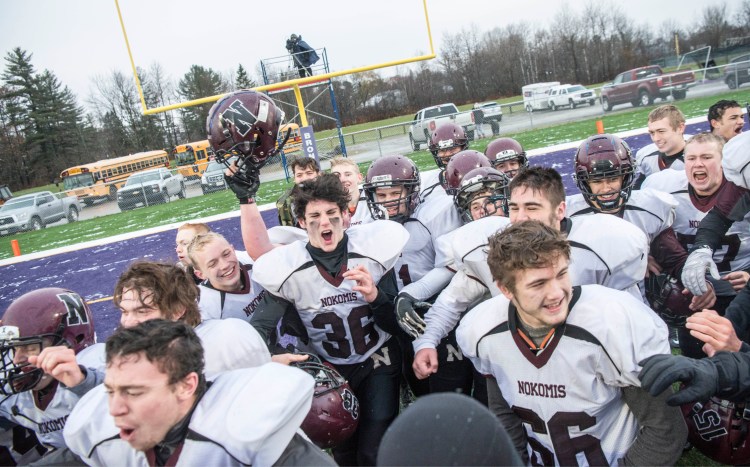Nokomis celebrates after beating Hampden Academy 13-6 to win the Class C North final on Saturday in Hampden.