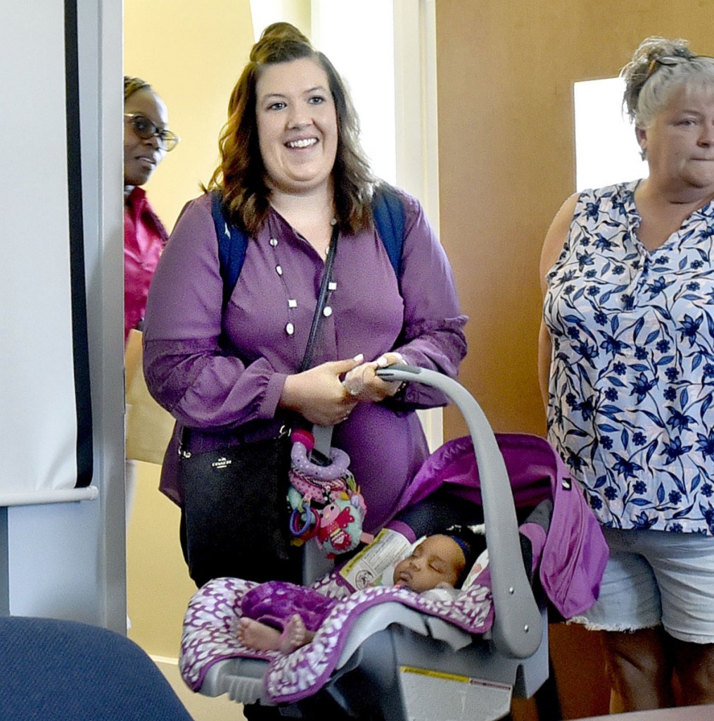 Mindy Saint Martin is seen July 19 with her infant daughter, Mya, for a hearing with the Department of Corrections Pardon Board in Augusta regarding a pardon for her husband, Lexius.
