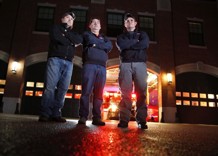 South Portland Deputy Fire Chief Bill Collins, center, with firefighters Luis Tirado, left, and Hale Fitzgerald, were among the five firefighters who rushed into a burning house on Kincaid Street on Wednesday night and found a 33-year-old woman who was trapped upstairs.