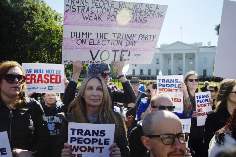 Demonstrators hold signs in support of trans equality outside the White House on Oct. 22 after President Trump threatened to roll back protections for transgender people.